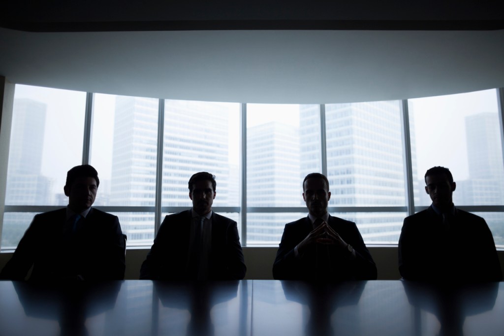 Silhouette row of businessmen sitting in meeting room